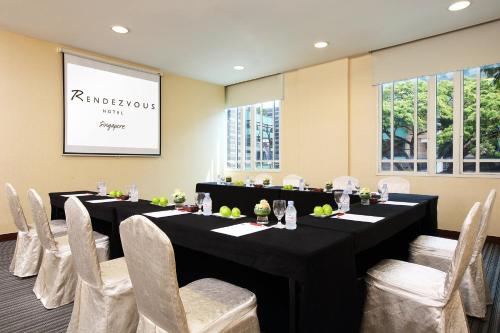a conference room with a long table and chairs at Rendezvous Hotel Singapore by Far East Hospitality in Singapore