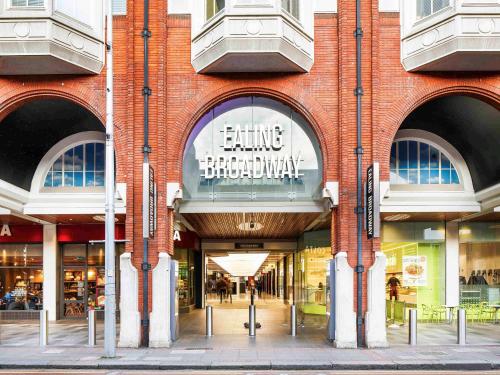a large brick building with an entrance to a store at ibis Styles London Ealing in London