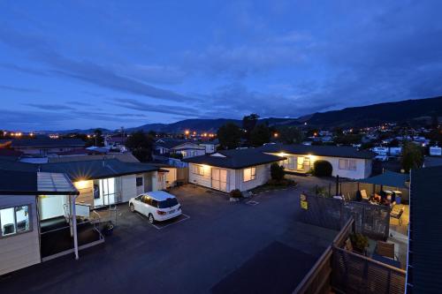 a car parked in a parking lot in front of houses at Richmond Motel and Holiday Park in Richmond