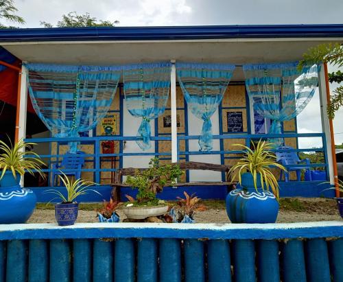 a blue house with plants inront of it at Bolo Beach Santorini nearby to Hundred Island in Alaminos