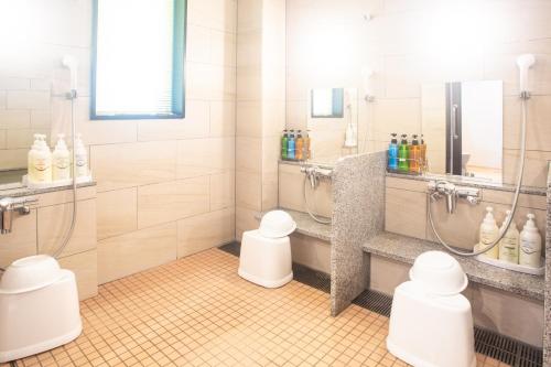 a bathroom with two toilets and a shower at Kuretake Inn Nankai Sakai-Ekimae in Sakai