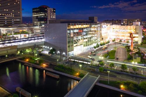 a city at night with a river and buildings at Kuretake Inn Nankai Sakai-Ekimae in Sakai