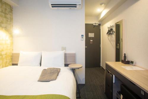 a hotel room with a bed and a sink at Kuretake Inn Nankai Sakai-Ekimae in Sakai