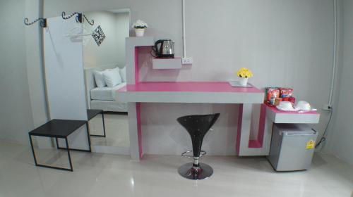 a pink doll house with a sink and a stool at Ma Non Nont Hotel & Apartment in Nonthaburi