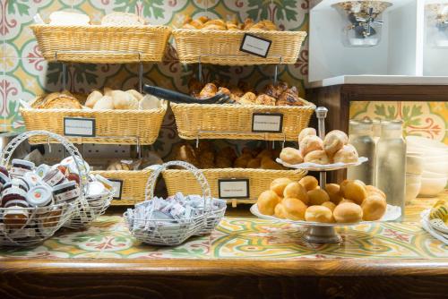 a table with baskets of bread and baskets of pastries at Palazzo Violetta in Sliema