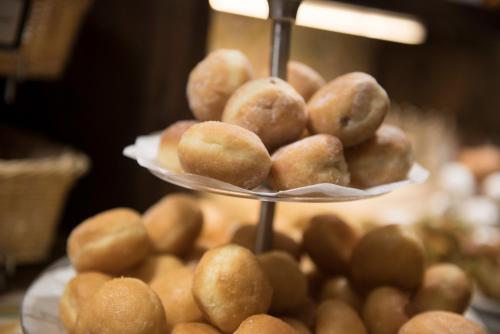 a pile of donuts sitting on a display plate at Palazzo Violetta in Sliema