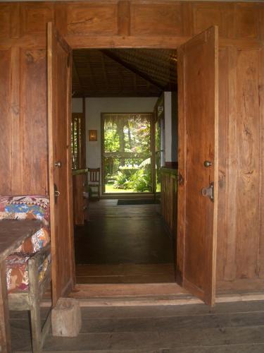 an open door to a room with a porch at Bali Beach Eco Villas Pondok Matekap in Selemadeg