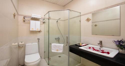 a bathroom with a shower and a toilet and a sink at Van Mieu Hotel in Hanoi