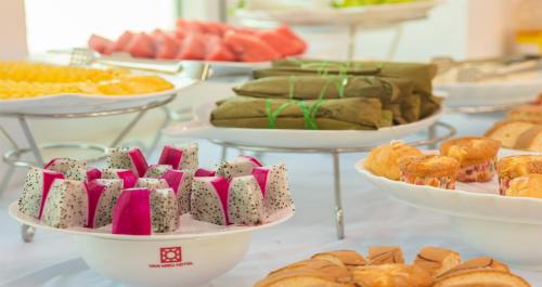 a buffet filled with different types of pastries and bread at Van Mieu Hotel in Hanoi