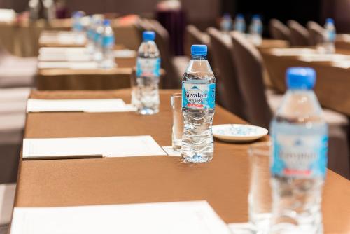 a row of tables with bottles of water on them at Hotel Valletta in Jiaoxi