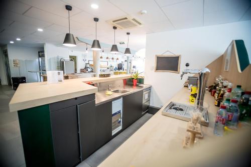 a kitchen with a sink and a counter top at Kyriad Clermont-Ferrand-Sud - La Pardieu in Clermont-Ferrand