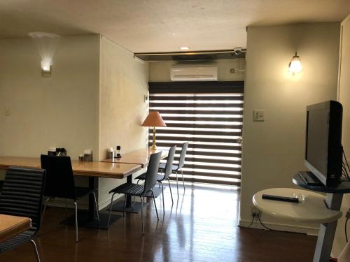a dining room with a table and chairs at Business Stay in Satsumasendai