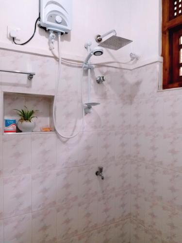 una doccia con soffione in un bagno di Unique Villa a Kandy