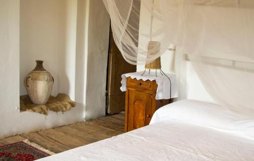 a bedroom with a bed and a vase on a table at Ca' Amorino in Galzignano