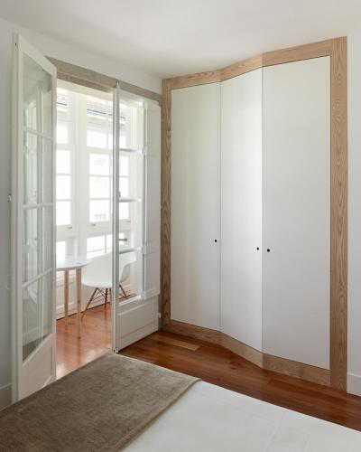 a room with white sliding doors and a table with a table at Hotel Pazo de Altamira in Santiago de Compostela