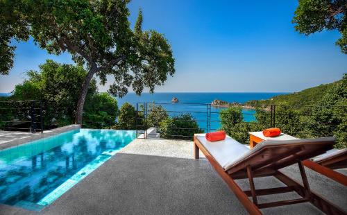 a swimming pool with a view of the ocean at Philip's Villa in Koh Tao