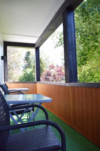 a table and chairs on a screened in porch at Haus Partale in Oberstdorf