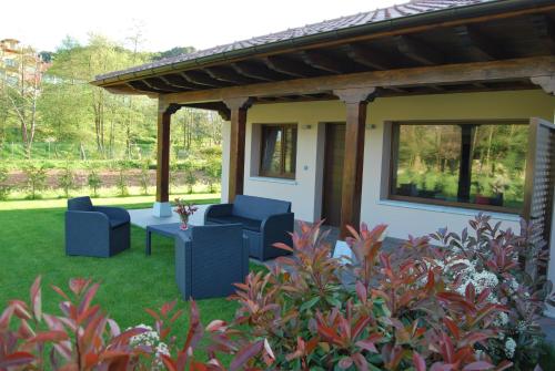 a covered patio with two chairs and a table at The Cool Houses in Llanes