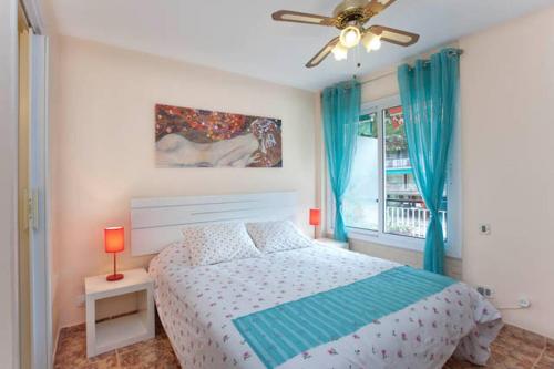 a bedroom with a bed and a ceiling fan at Apartment Llavaneres I in Sant Andreu de Llavaneres