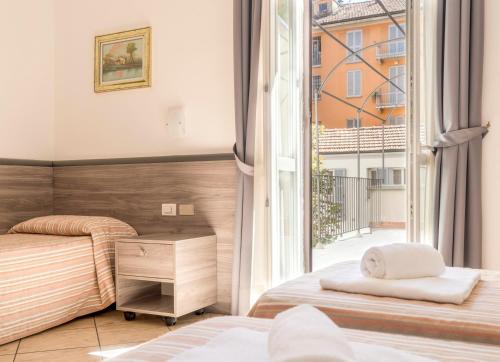 En eller flere senge i et værelse på Hotel Brianza