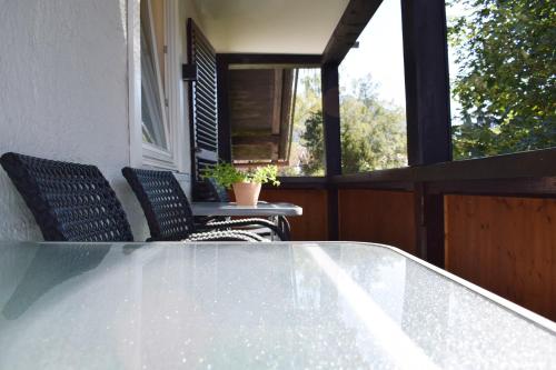 a table and two chairs on a balcony with a table and chairs at Haus Partale in Oberstdorf
