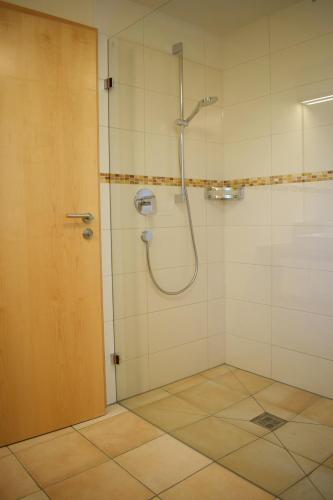 a shower with a glass door in a bathroom at Haus Partale in Oberstdorf