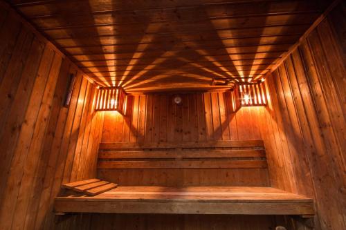 a wooden sauna with two lights on the ceiling at Tai Pan Hotel in Bangkok