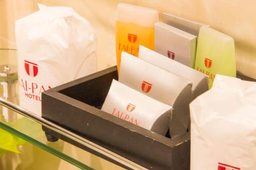 a shelf with a box of klayonigeriger at Tai Pan Hotel in Bangkok