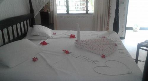 a bed with a cake with a candle on it at Scorpio Villas Resort in Malindi