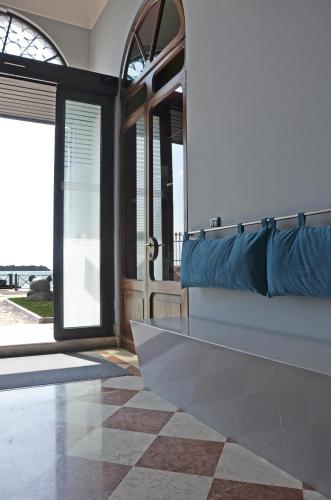 a room with a couch and a door with a porch at Isola di San Servolo - Centro Soggiorno in Venice