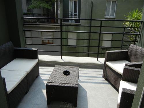 a balcony with two chairs and a coffee table at Delle Nazioni Milan Hotel in Milan