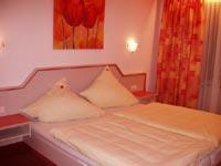 a bed with two pillows on it in a bedroom at Hotel Igel in Püchersreuth