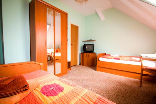 a bedroom with a bed and a tv in it at Christel's Pension in Brandenburg an der Havel