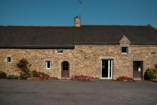 a large brick building with flowers in front of it at La Longere d'Helene in Lauzach