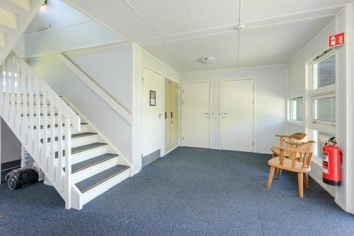 a room with a staircase and a chair at Hafjell Alpinlandsby Pluss in Hafjell