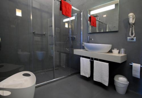 a bathroom with a shower and a sink and a toilet at Hotel Garnì Villa Maria in Riva del Garda