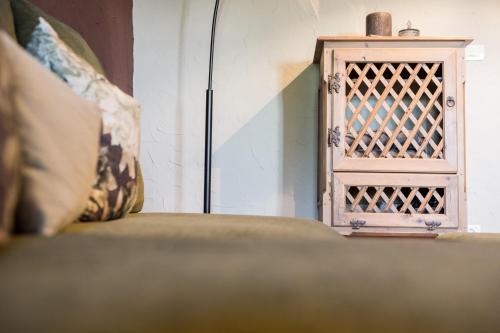 a couch sitting next to a wooden box at Chalet Hafling Zoila in Avelengo