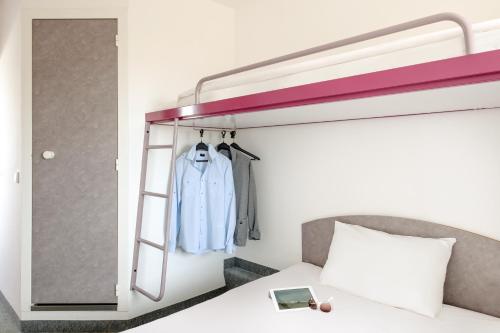 a bedroom with a bunk bed with a blue jacket at CREO Halle Peissen in Peißen