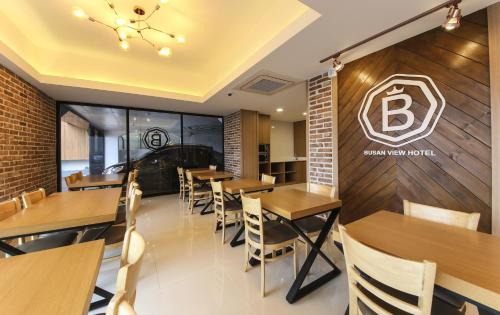 a dining room with wooden tables and chairs at Busan Station BUSAN VIEW HOTEL in Busan