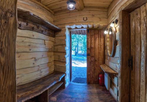 a wooden hallway in a log cabin with a door at Гостинний двір на хуторі Хрещатик in Khreshchatik