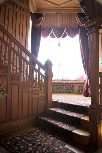 a room with stairs and a large window at Alexander Mansion Bed & Breakfast in Winona