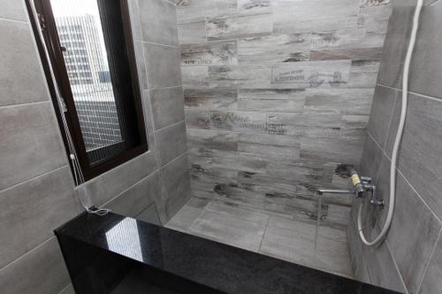 a bathroom with a shower with a black counter at Yixiang Spring Travel in Jiaoxi