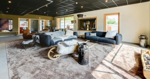 un ampio soggiorno con divani e un tappeto di TERRESENS - Les Fermes du Mont-Blanc a Combloux