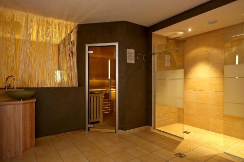 a bathroom with a sink and a glass shower at Residence Ciasa Mirasas in Badia