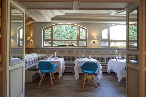 a restaurant with two tables and two windows at Sporthotel Leweck in Lipperscheid