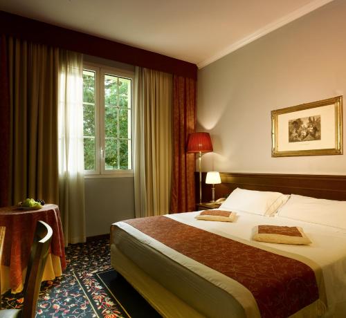 a hotel room with a bed and a window at Meditur Hotel Bologna in Bologna