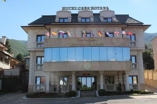 a large building with a flag on the front of it at Casa Boyana Boutique Hotel in Sofia