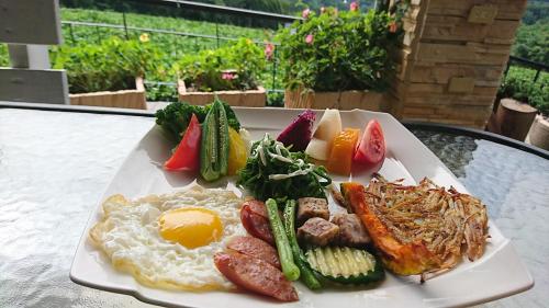 a plate of breakfast food on a table at View on View B&B in Puli