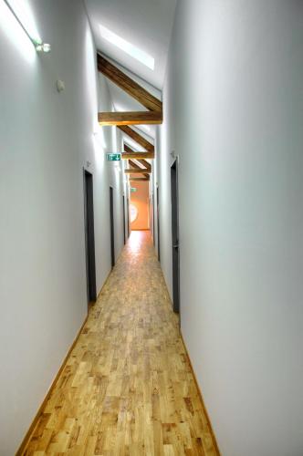 a corridor of an empty room with a long hallway at Depot 195 - Hostel Winterthur in Winterthur