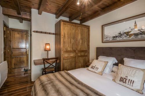 a bedroom with a large bed and a wooden ceiling at Solei by FeelFree Rentals in Garós